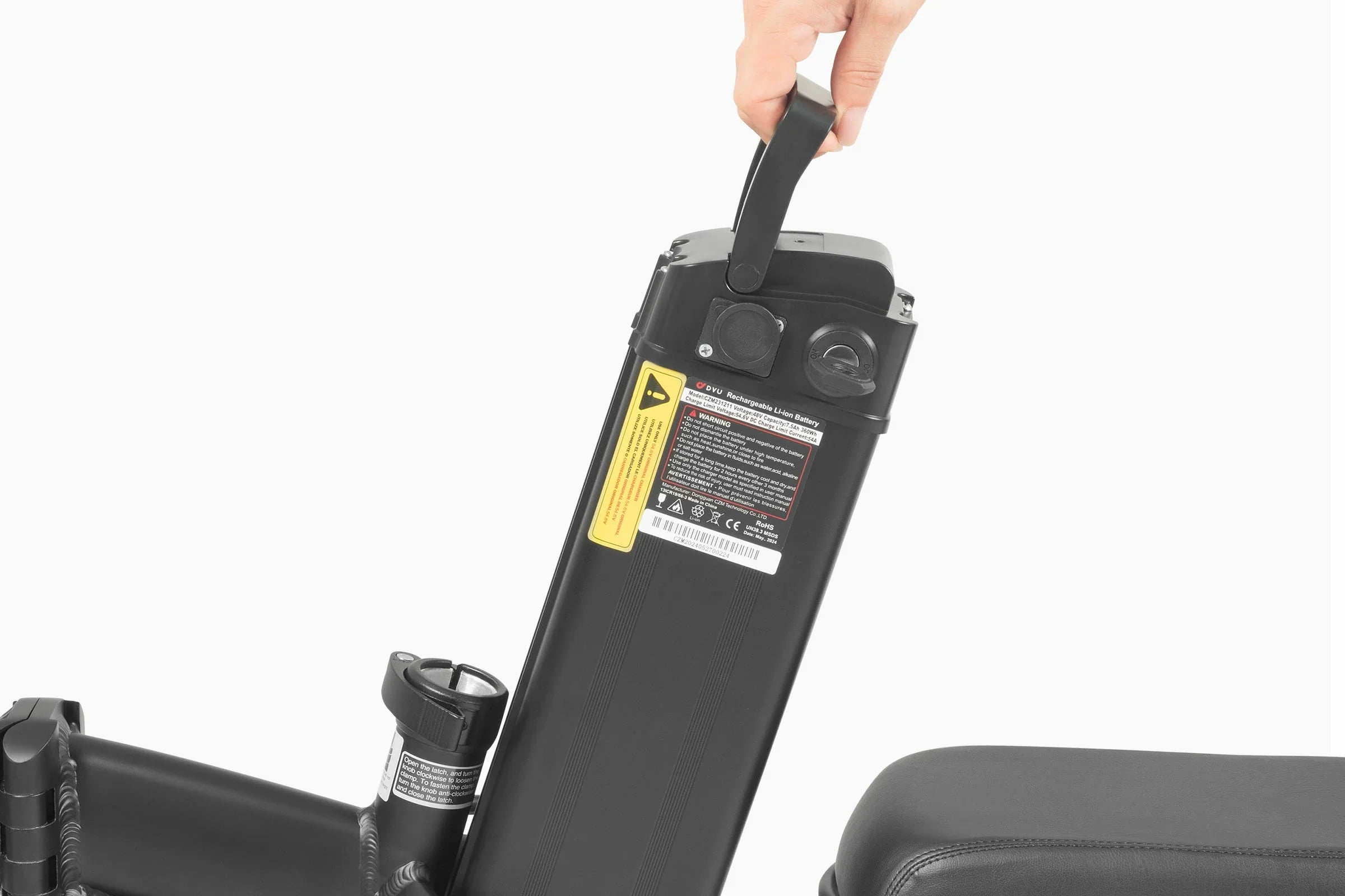 Hand holding a black DYU A5 Upgraded Folding Electric Bike battery pack with visible branding on a white background