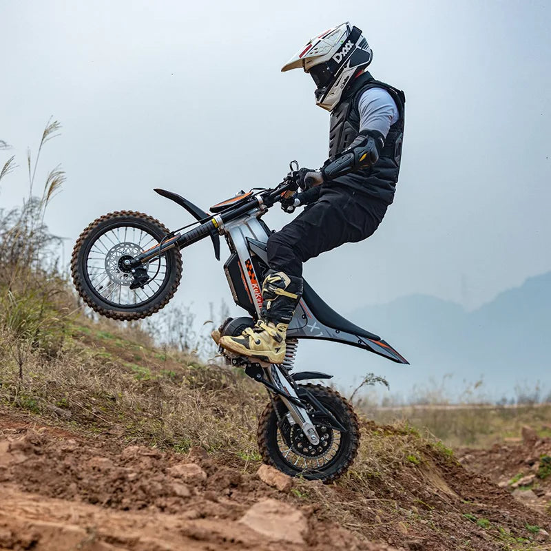 Person performing a wheelie on a KuKirin X1 Electric Scooter Motorcycle in an outdoor setting