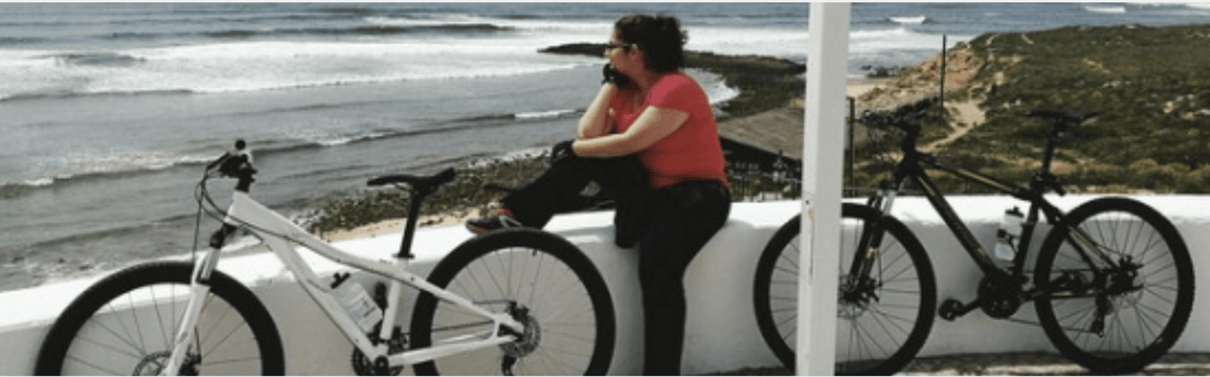 White and black electric bikes side view by the ocean on a coastal path