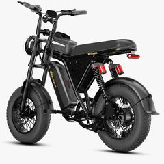 A black bodywel M16 Pro electric dirt bike with thick knobby tires, a high handlebar, and a sleek black seat, shown from a three-quarters rear angle on a light gray background.